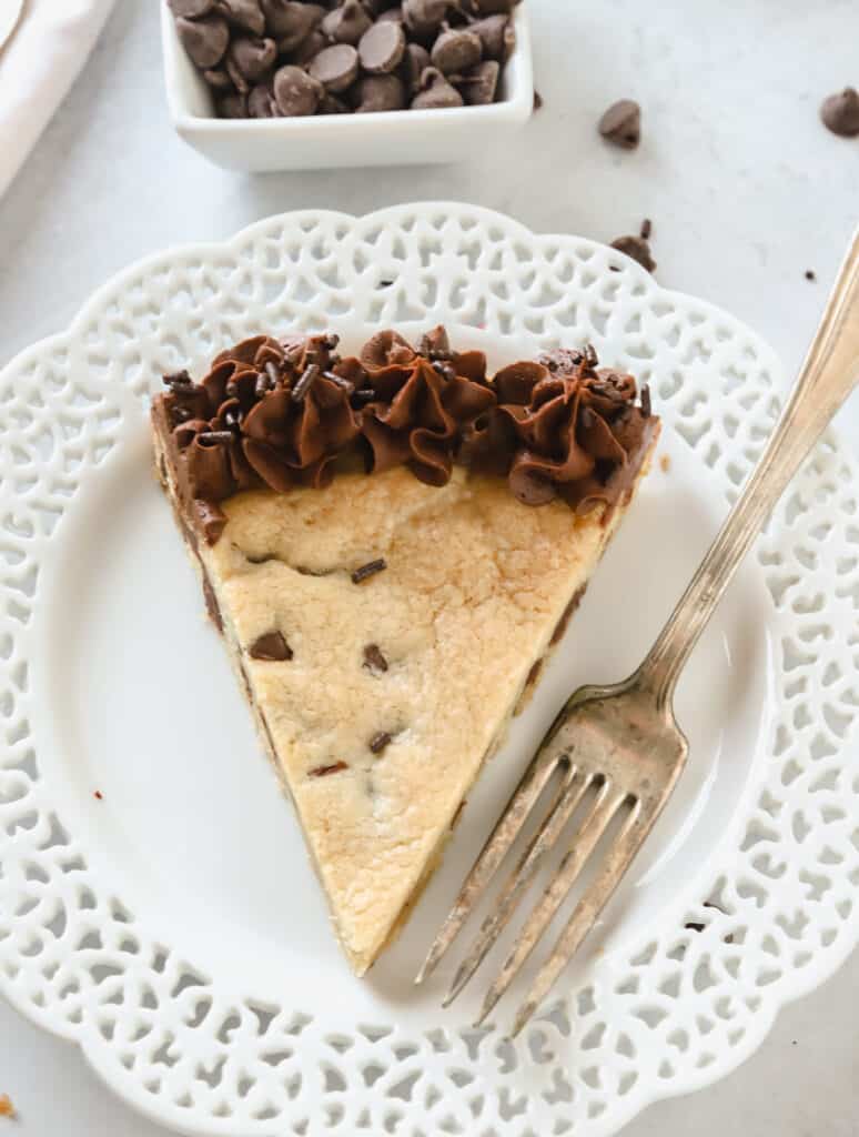 slice of chocolate chip cookie cake on a white plate with a fork