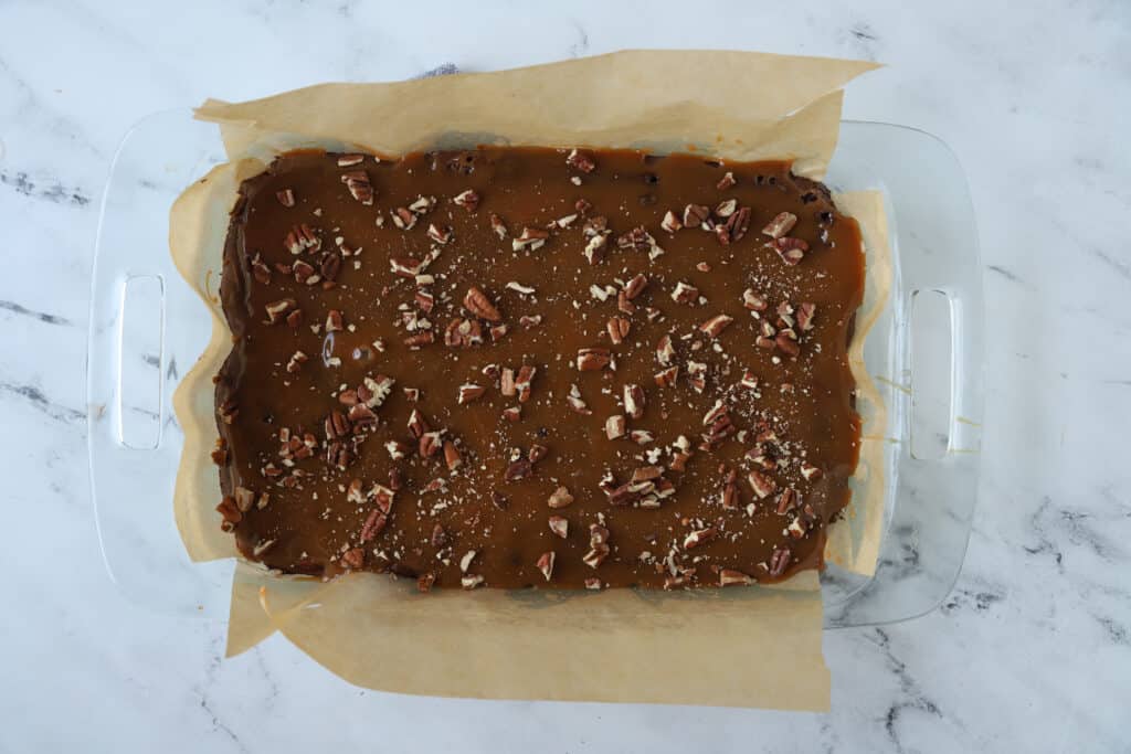 baked brownies topped with caramel and pecans