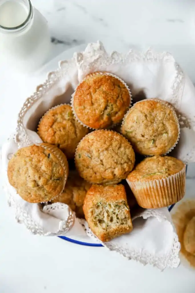 zucchini muffins in a linen lined bowl