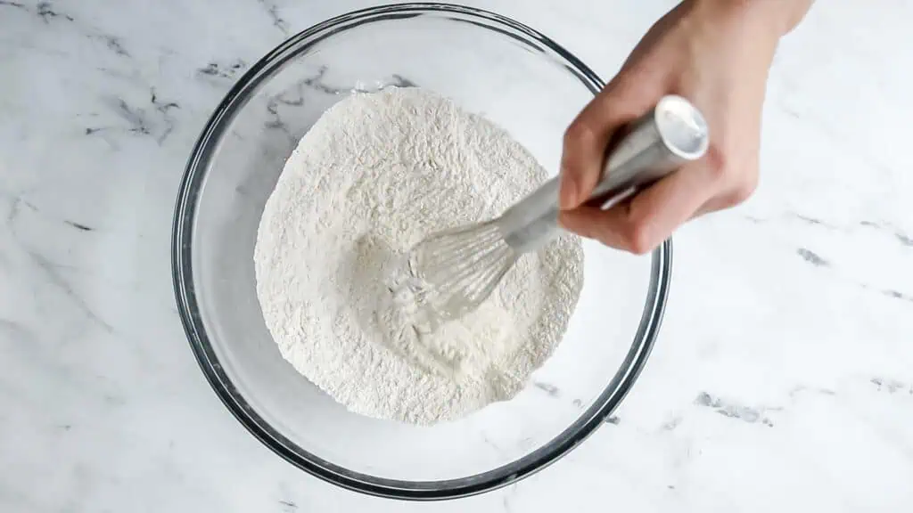 hand whisking a bowl of scone dry ingredients