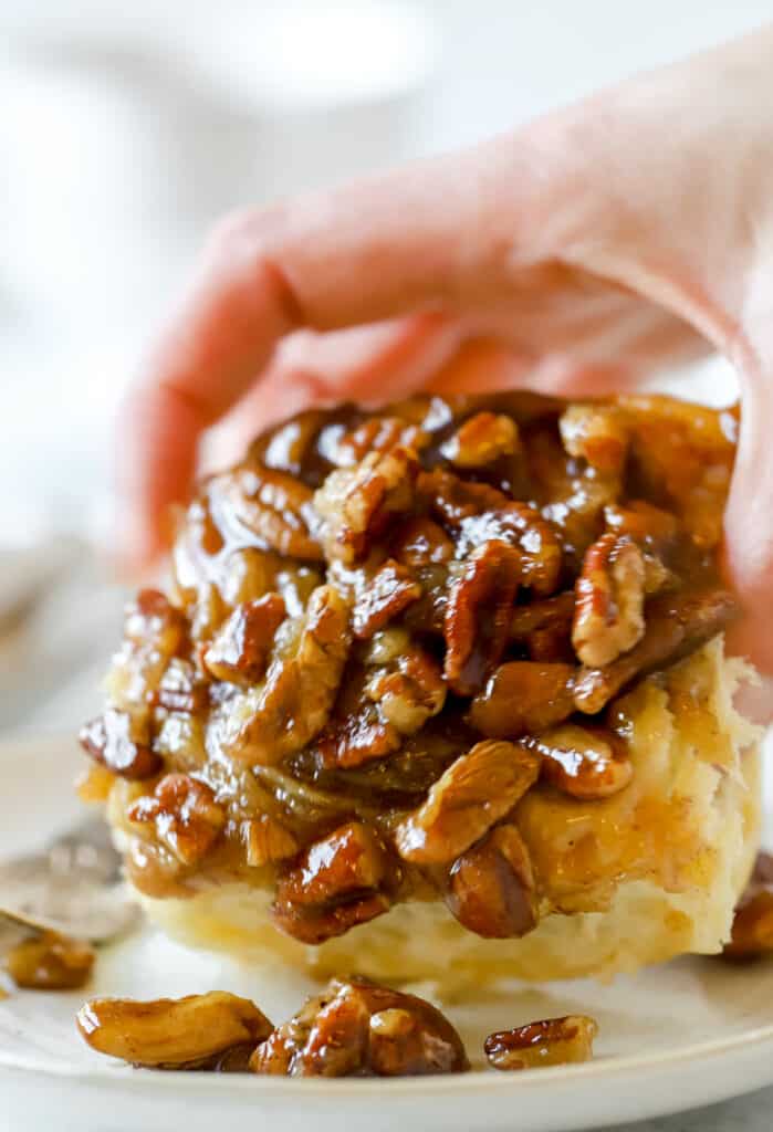 hand holding a pecan sticky buns