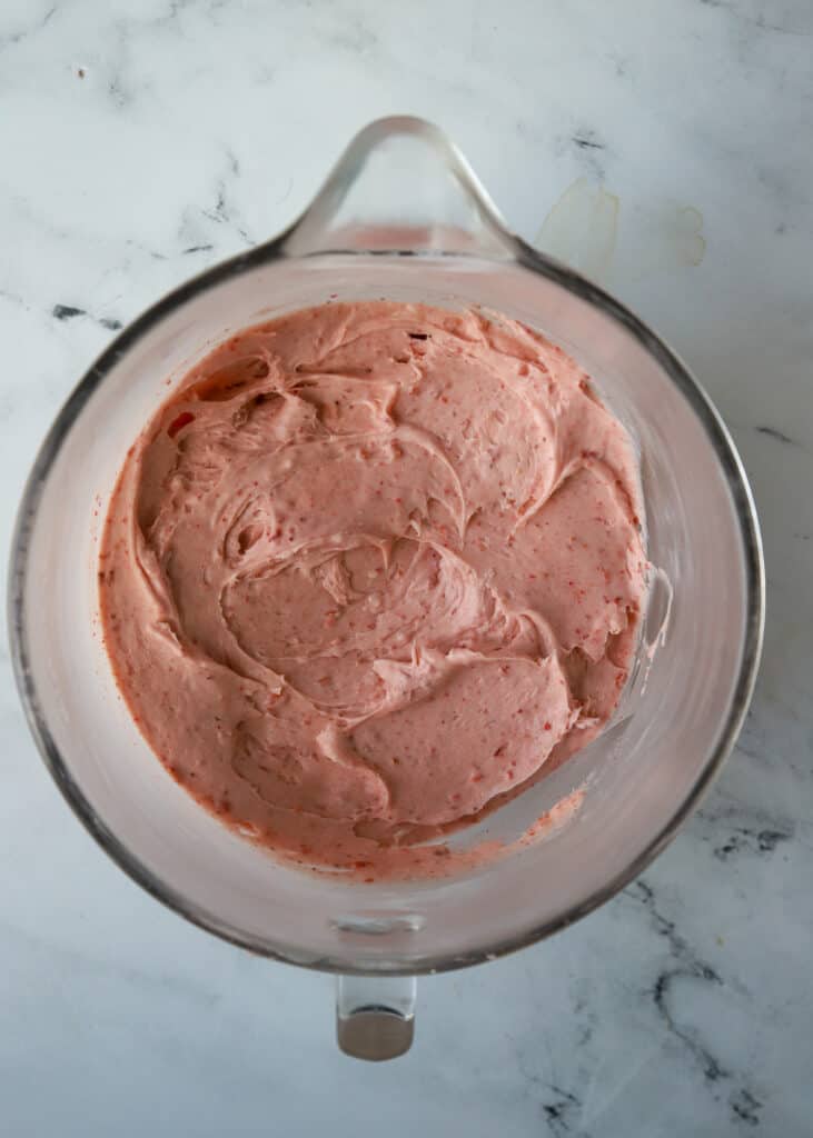 glass bowl of strawberry cream cheese frosting