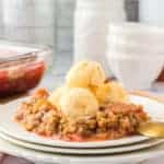plate of strawberry rhubarb crisp topped with icecream