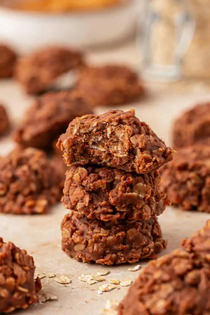three no bake cookies stacked on top of each other with a bite taken out of the top cookie