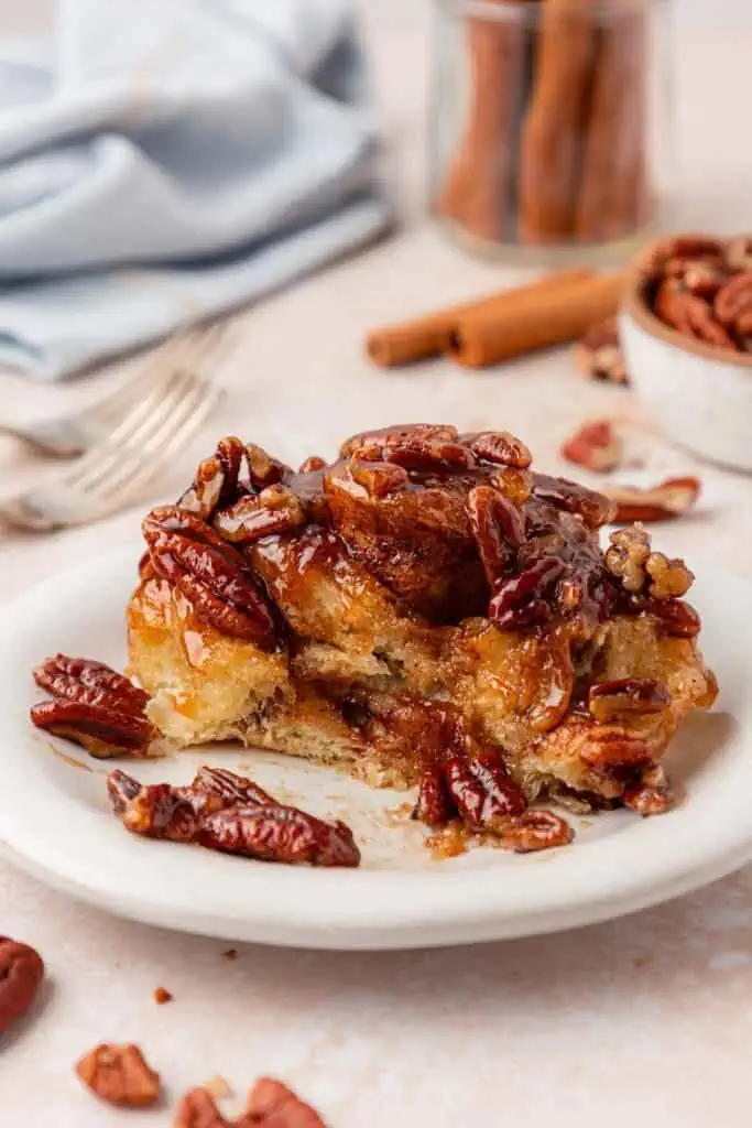 half eaten sticky bun on a plate