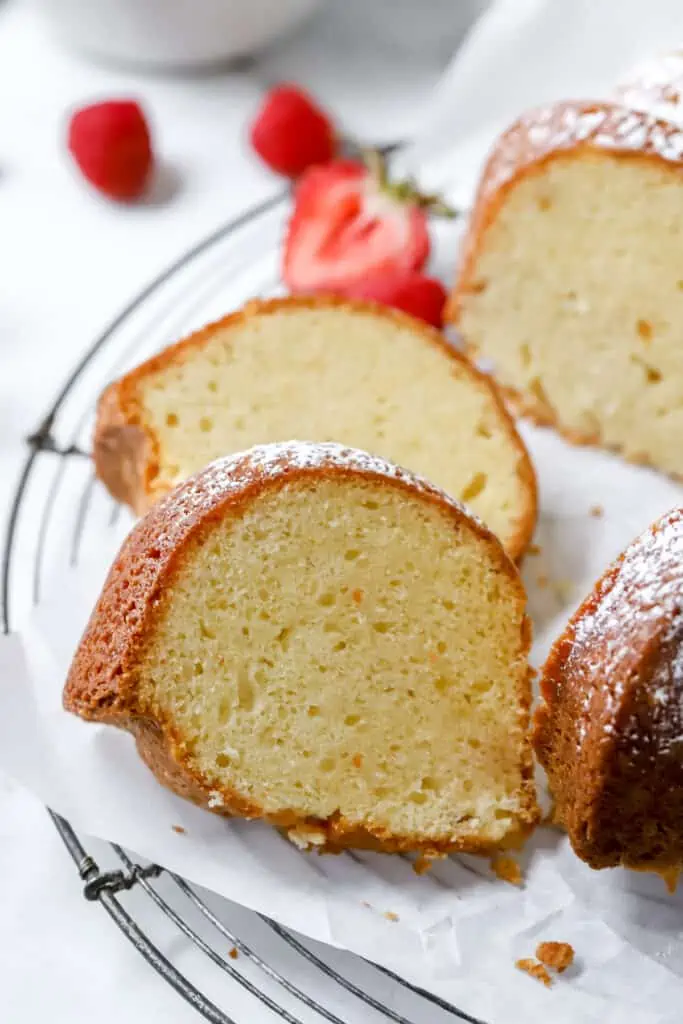 sour cream pound cake slices on a cooling rack
