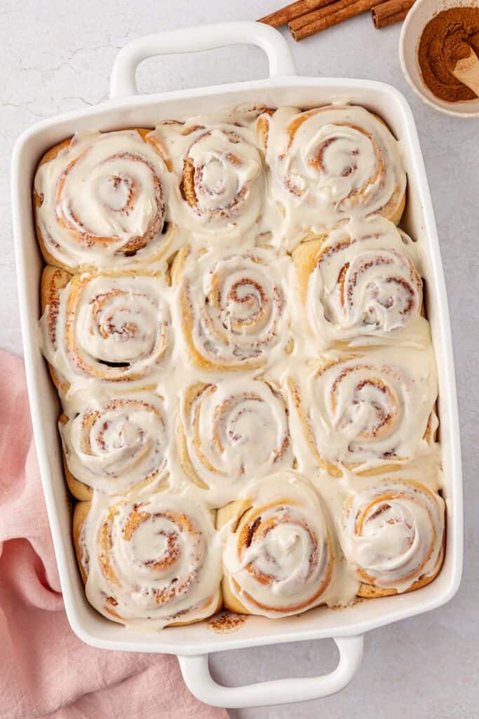 a pan of frosted cinnamon rolls