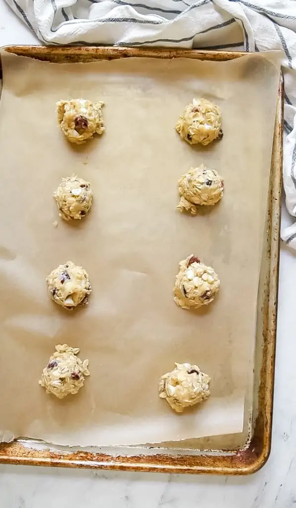 oatmeal white chocolate cranberry cookie balls scooped onto cookie sheet