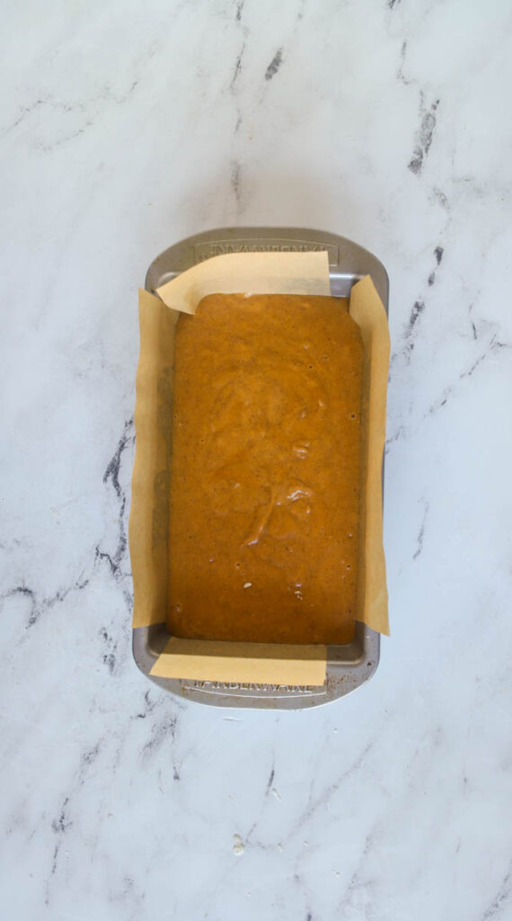 unbaked pumpkin bread batter in loaf pan