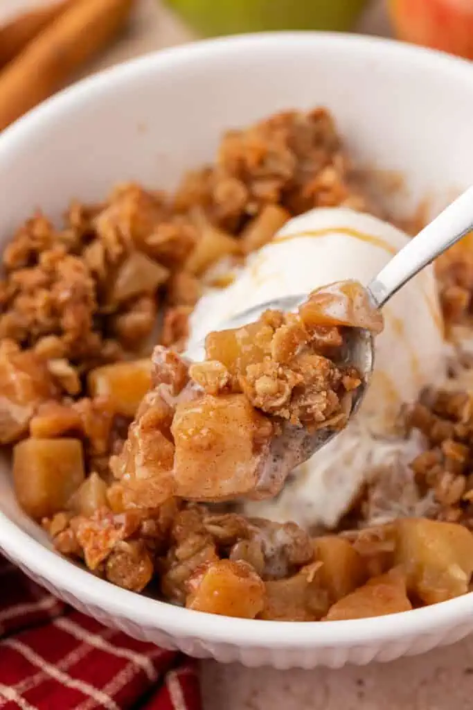 spoon holding a spoonful of apple crisp