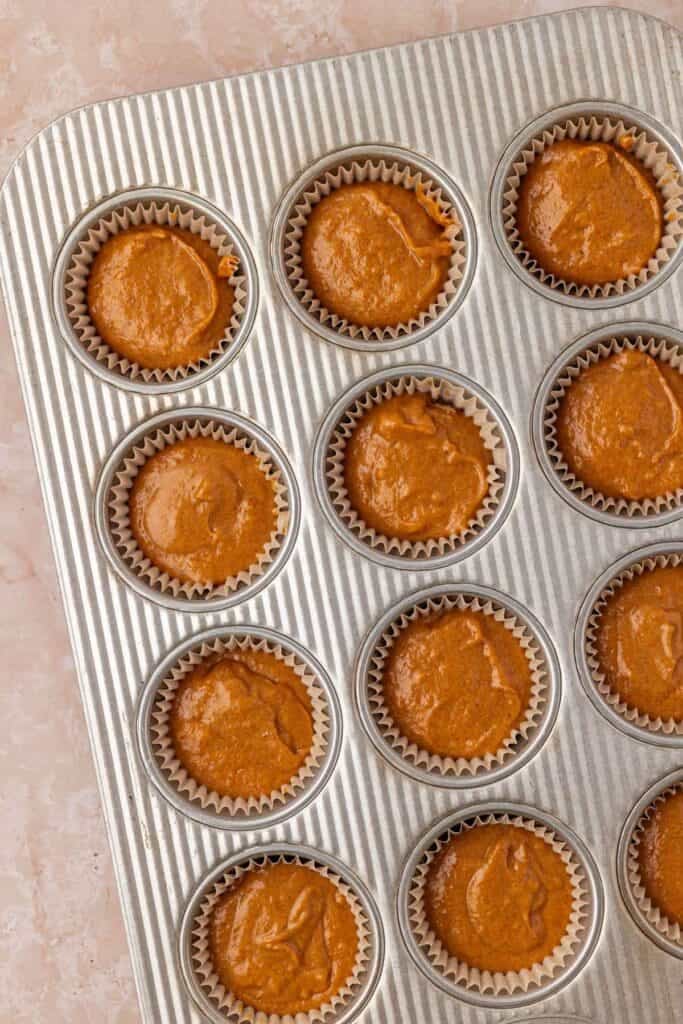 unbaked pumpkin cupcakes in a pan
