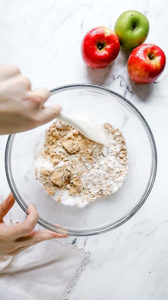 apple crisp oat topping being stirred together in bowl