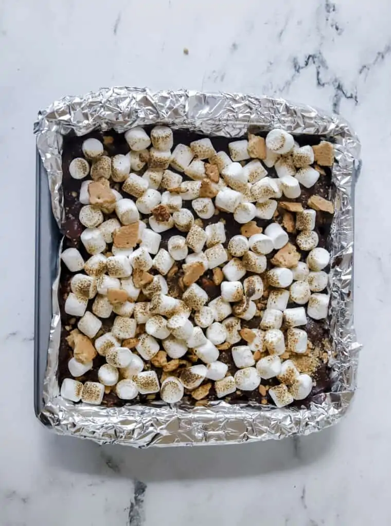 smores fudge in pan with toasted marshmallows on top