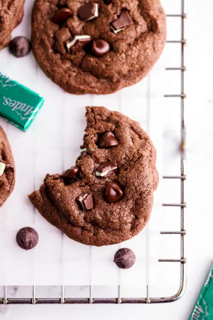 andes inint cookie with a bite taken out of it on parchment paper wire rack