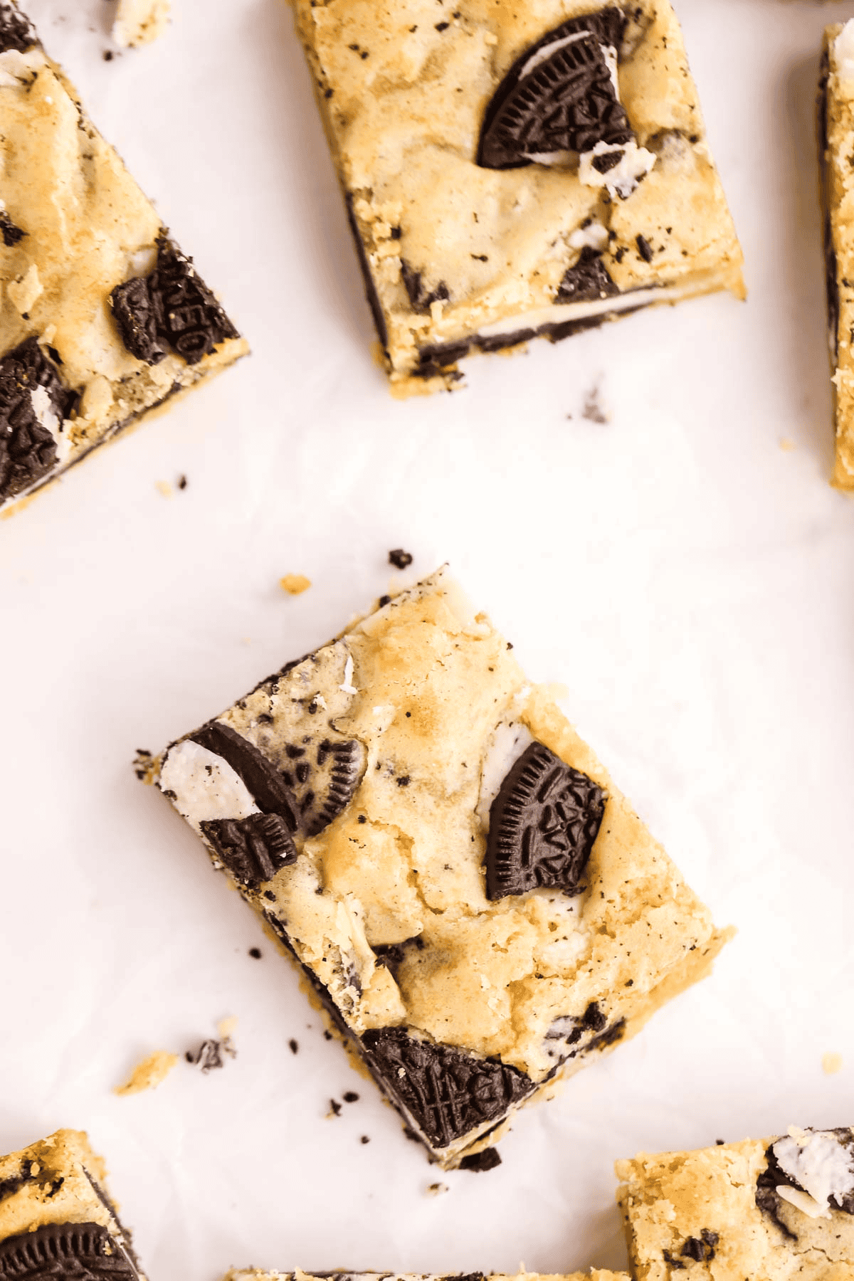 oreo blondies cut into squares on parchment