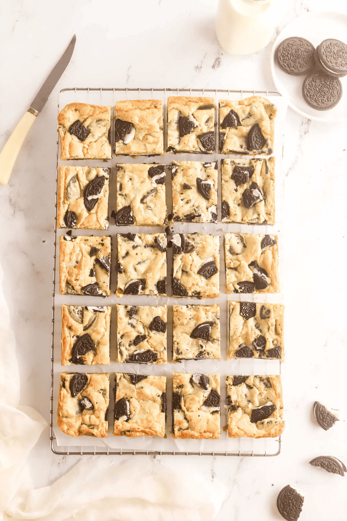 Oreo blondies cut into squares on a wire rack