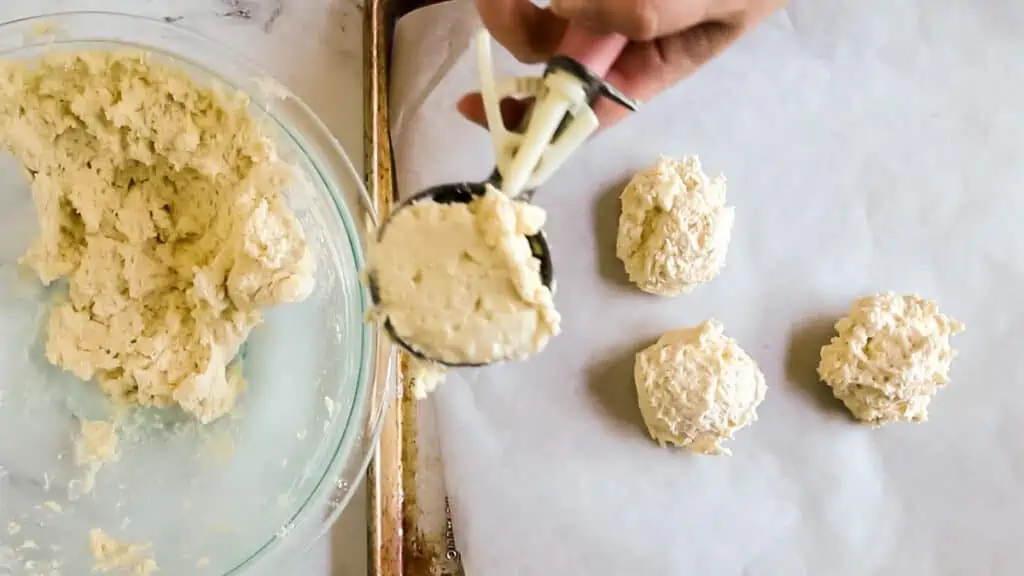 large scoop scooping biscuit dough