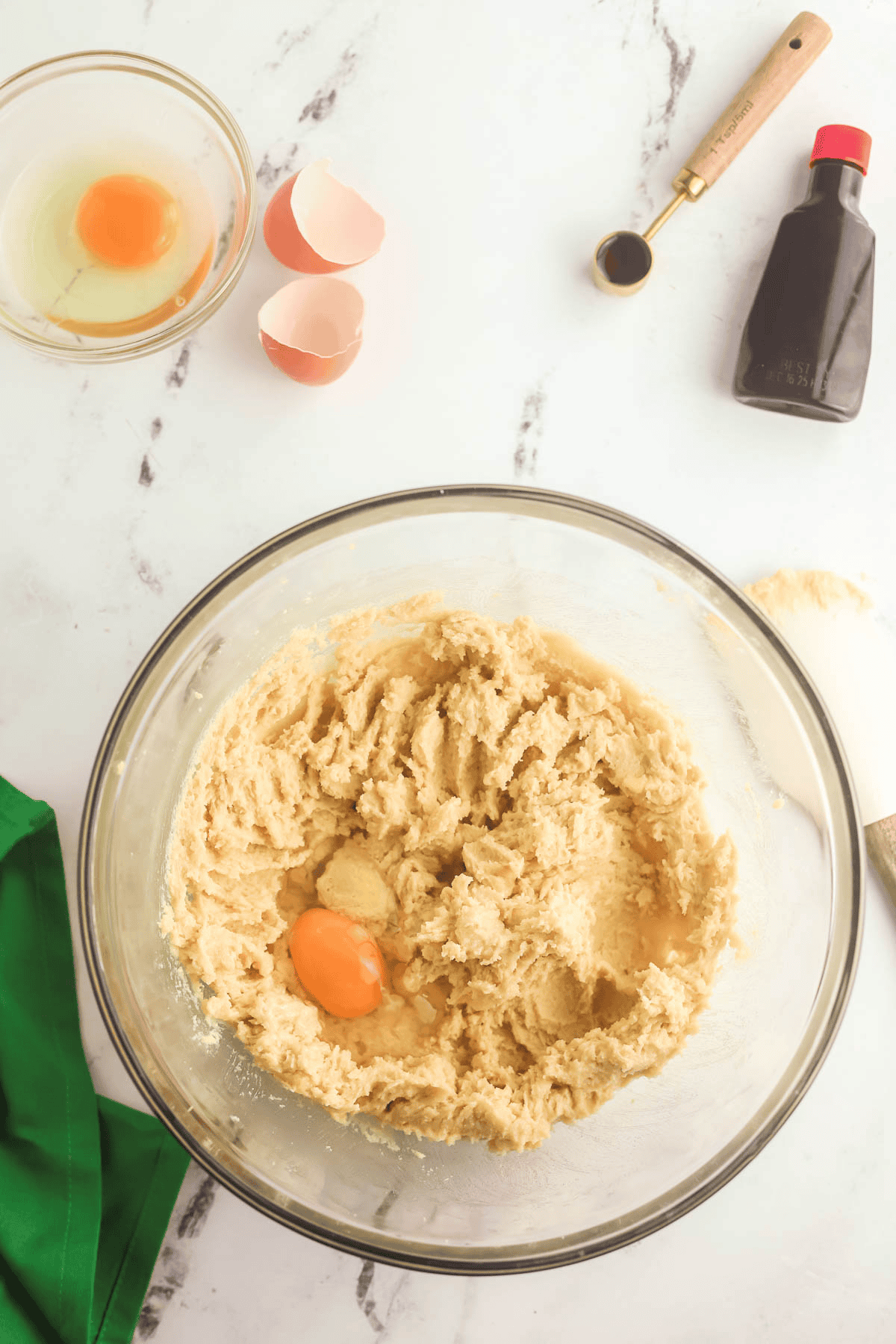egg added to bowl of creamed butter and sugars