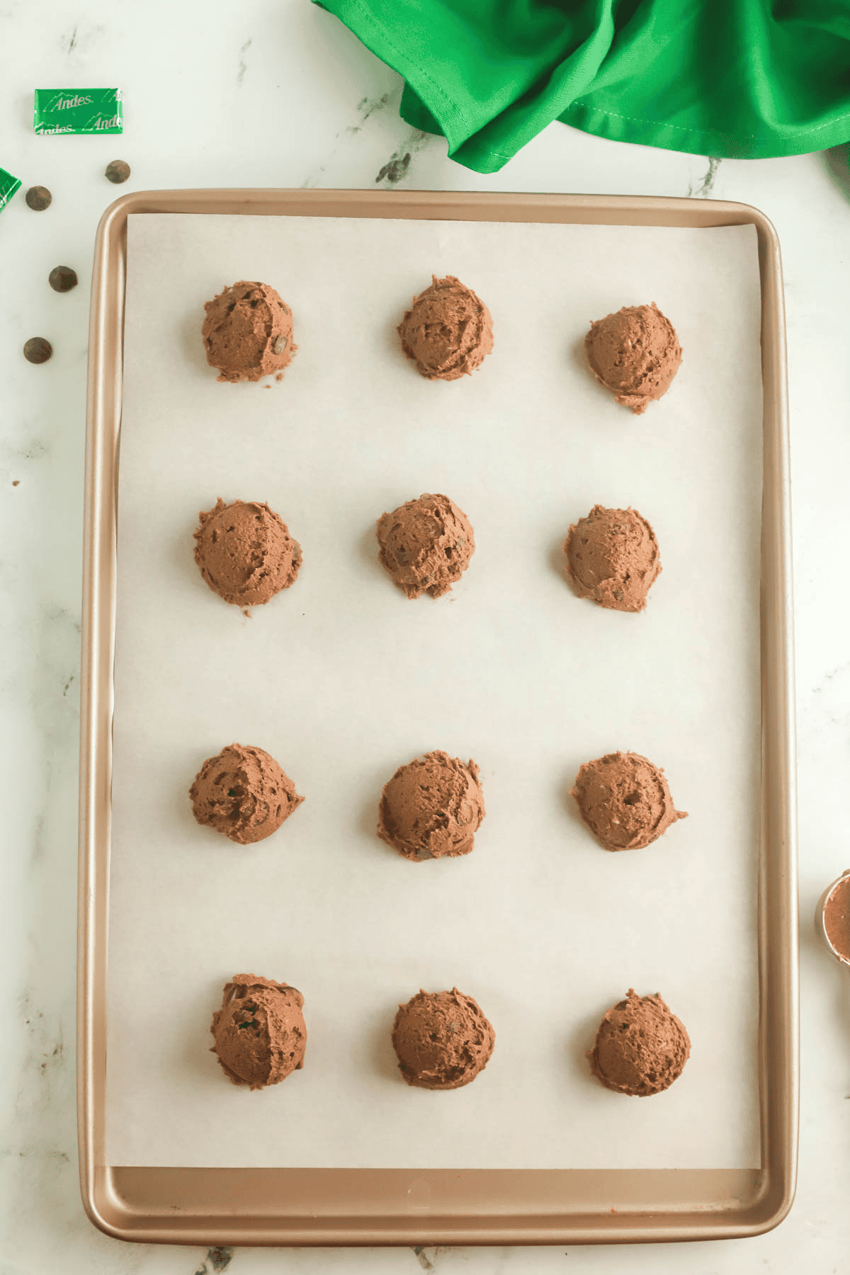Andes mint cookies scooped onto parchment paper lined baking sheet
