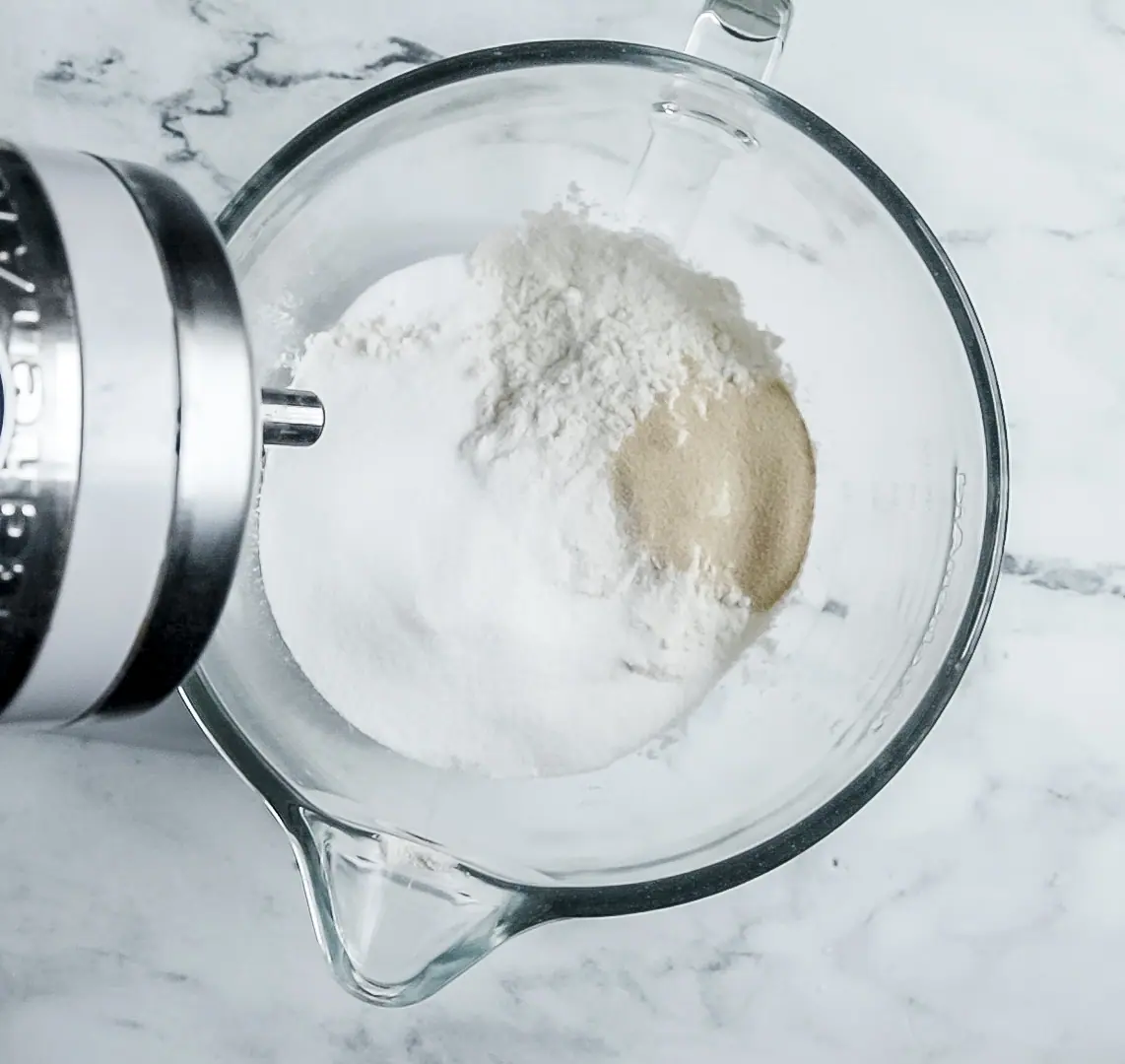 stand mixer bowl of flour, yeast, sugar and salt