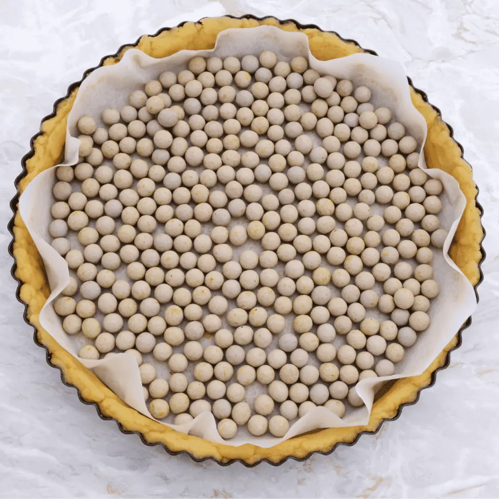 pie crust filled with parchment paper and pie weights