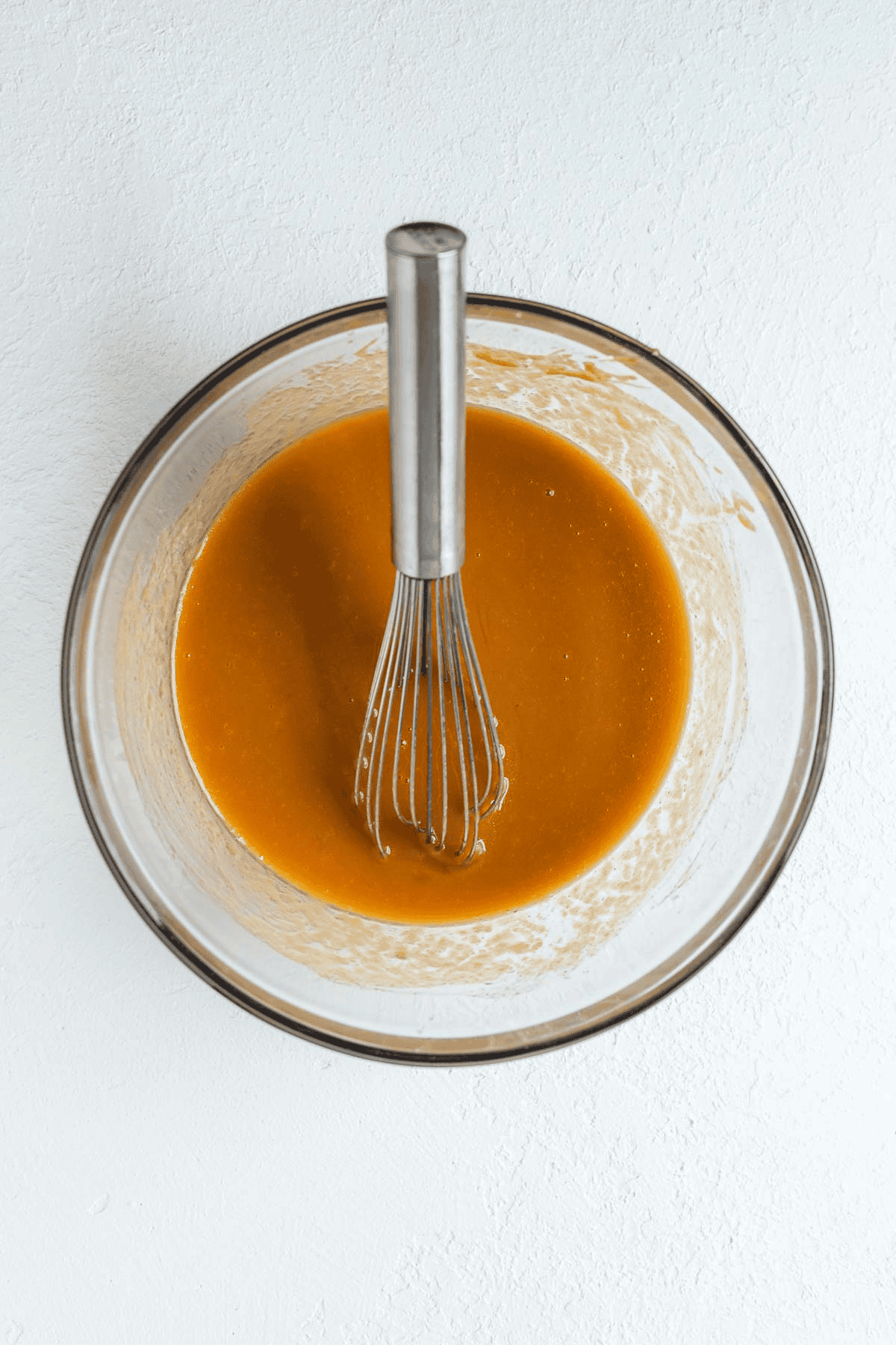 sweet potato wet ingredients in a bowl with a whisk