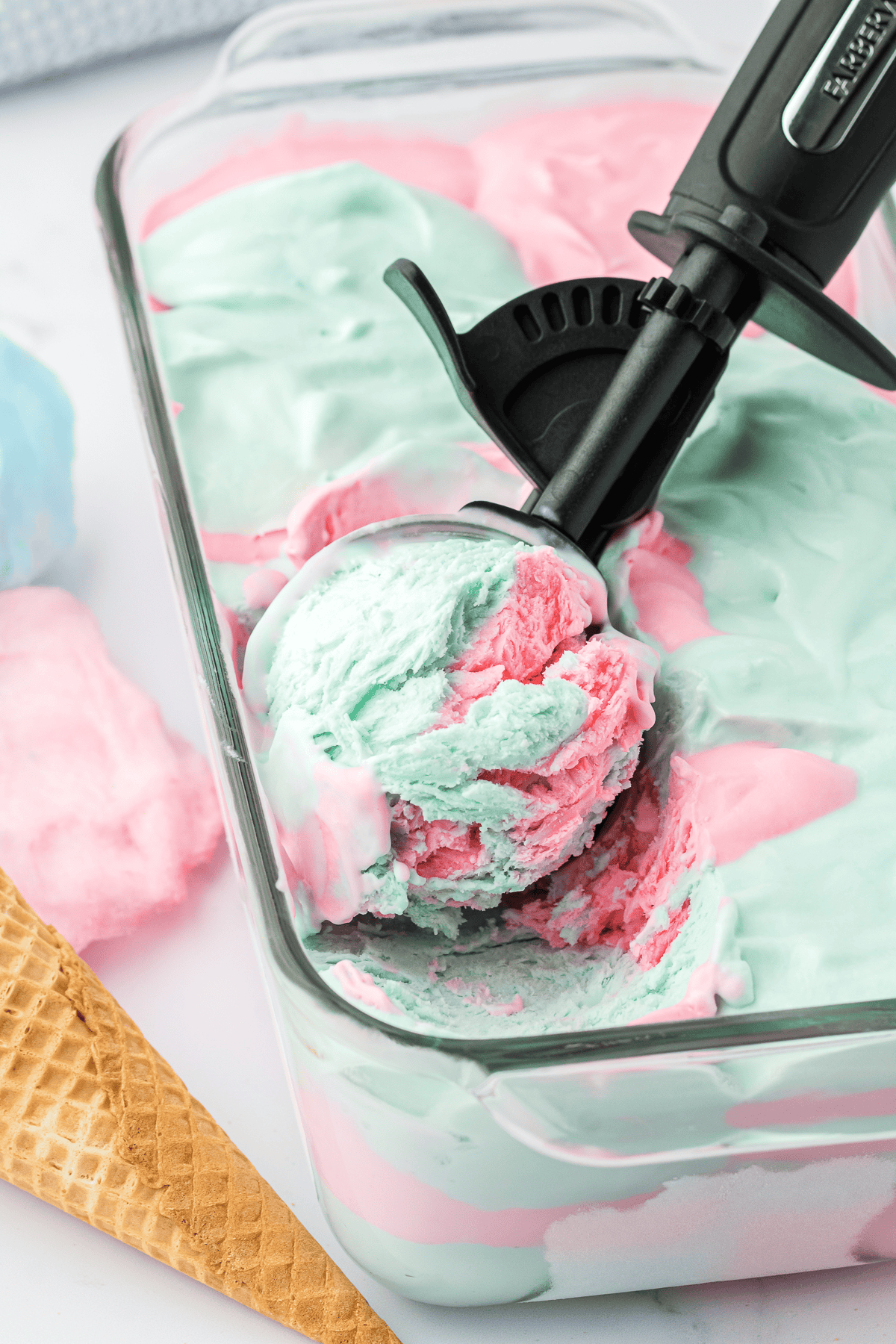 ice cream scoop in loaf pan of cotton candy ice cream