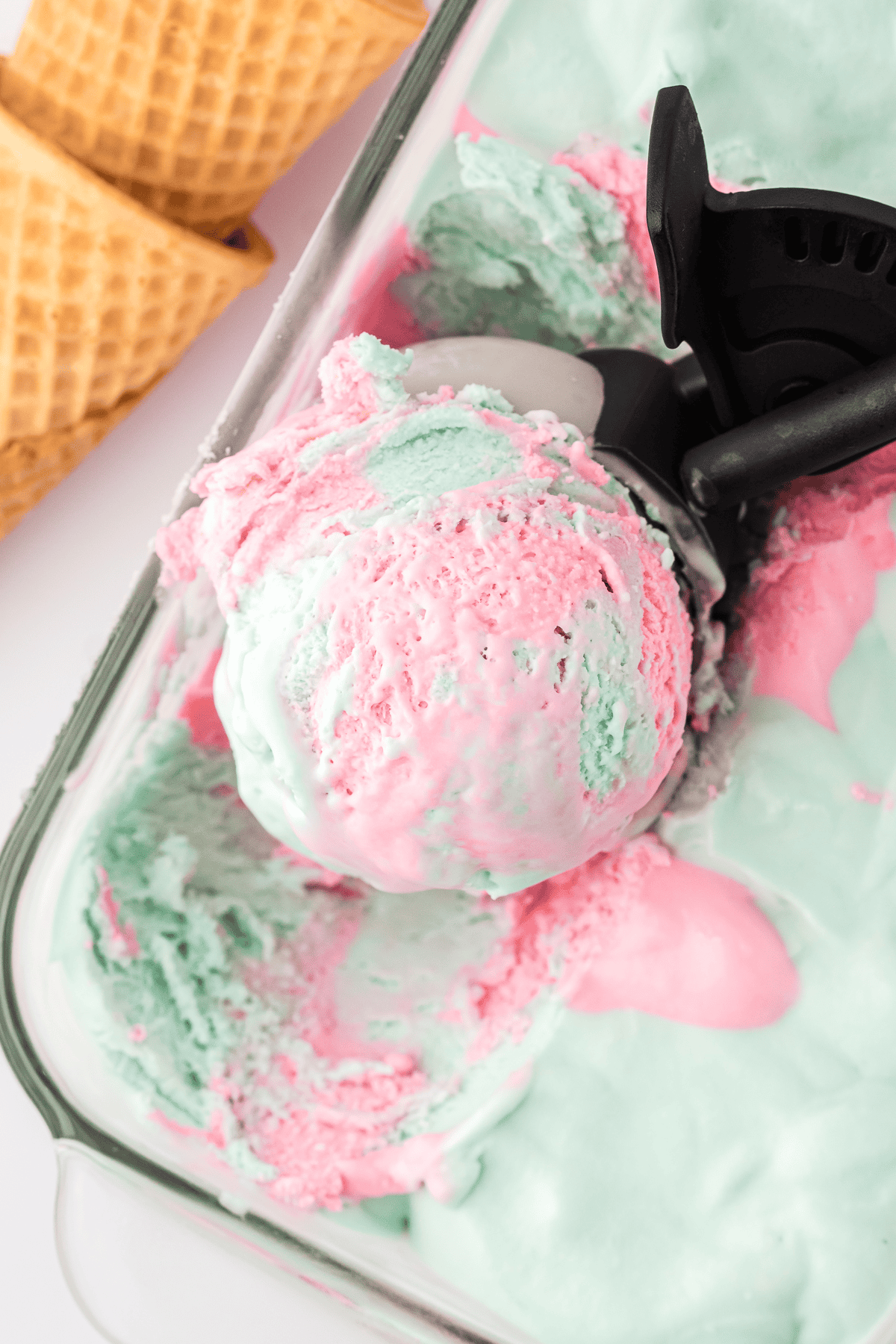 ice cream scoop with with scoop of cotton candy ice cream in loaf pan