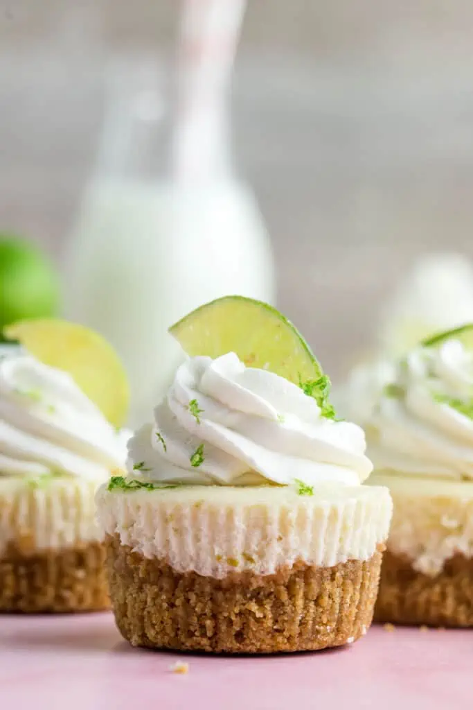 mini key lime cheesecake topped with whipped cream