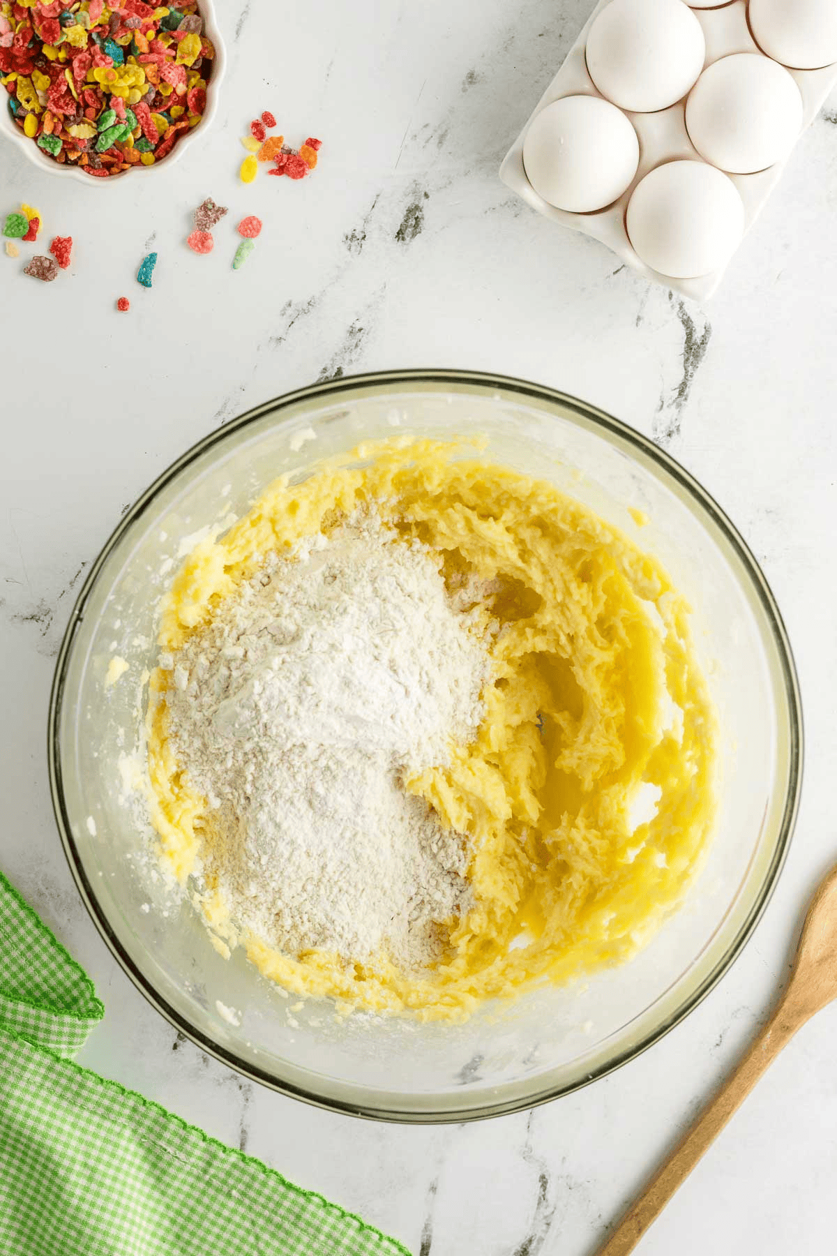 flour added to sugar cookie dough in bowl