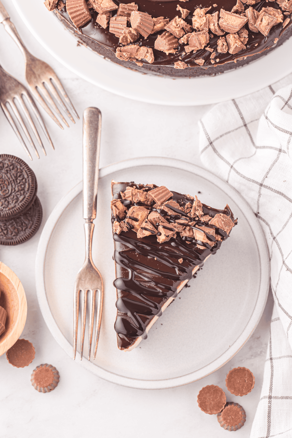 slice of no bake chocolate peanut butter cheesecake on a plate with a fork