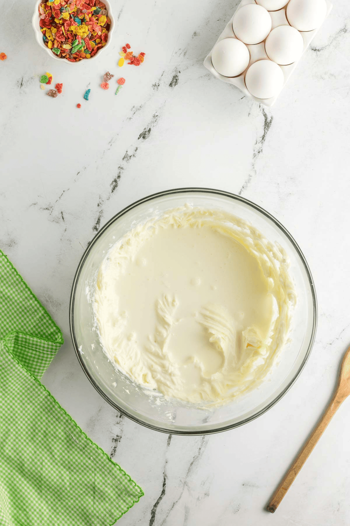 heavy cream added to cheesecake batter in bowl