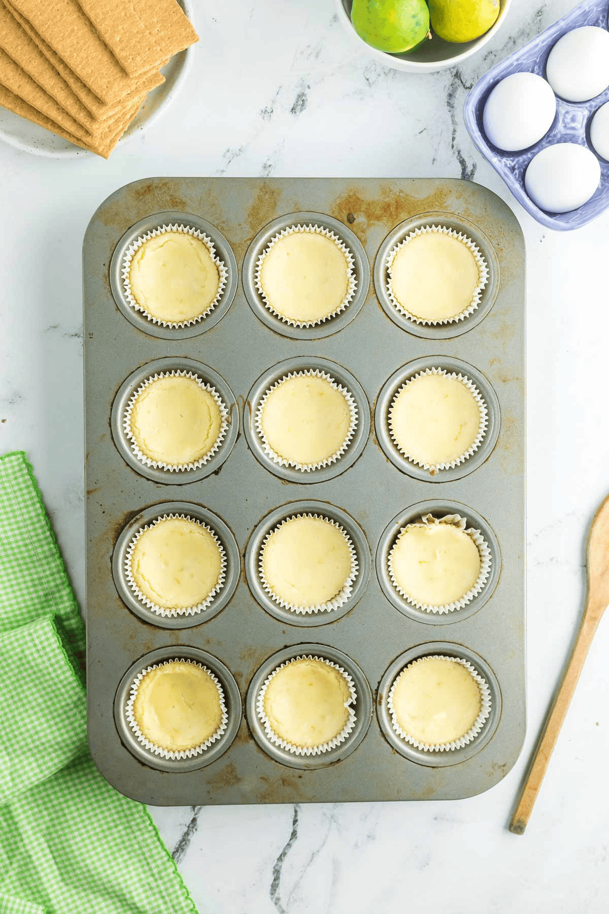 baked mini key lime cheesecakes in muffin tin