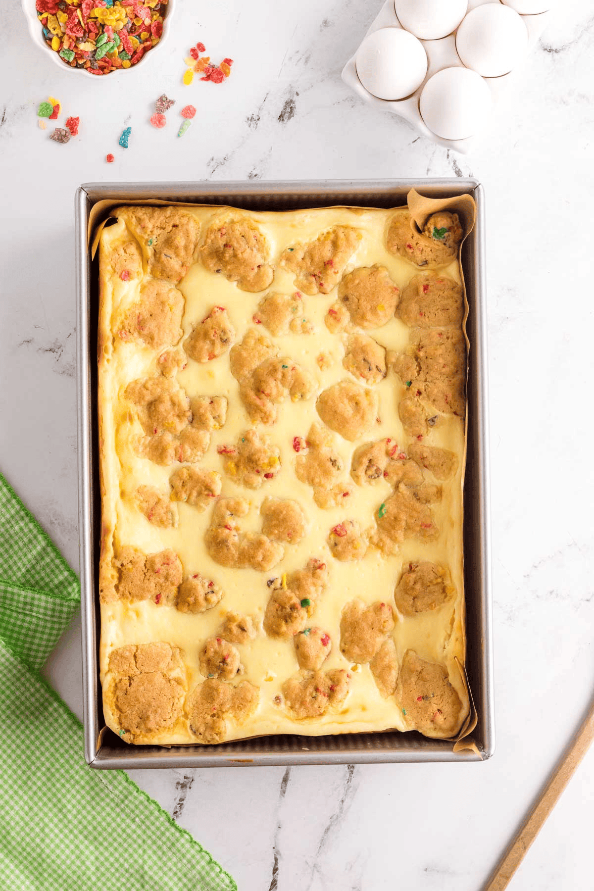 baked fruity pebble cheesecake bars in pan