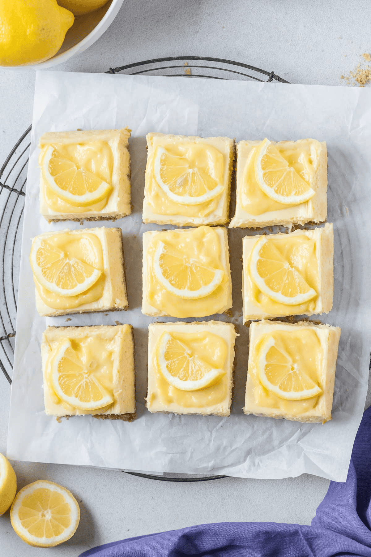 lemon cheesecake bars cut into squares placed onto wire rack