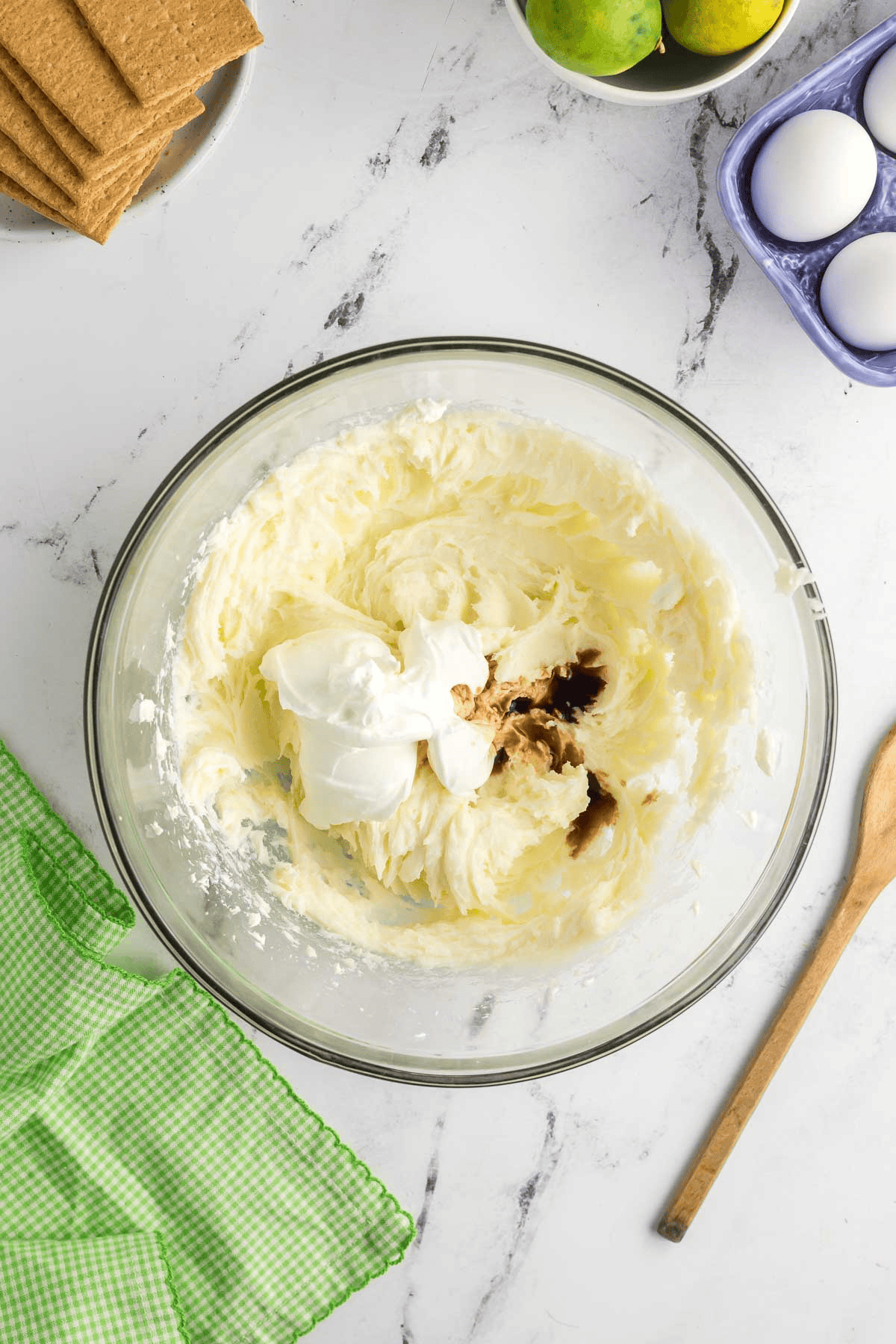 sour cream and vanilla added to cheesecake mixture in bowl