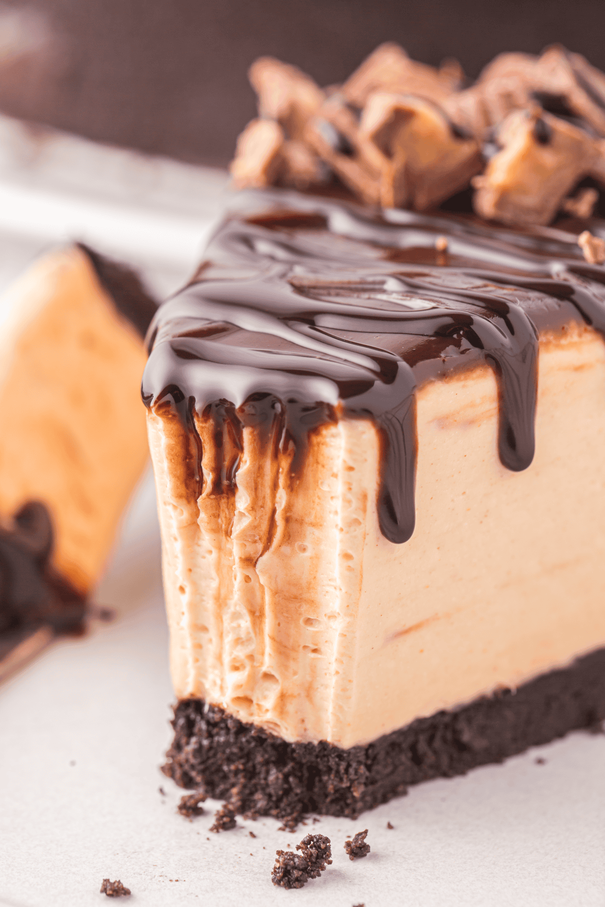 slice of no bake chocolate peanut butter cheesecake with bite missing
