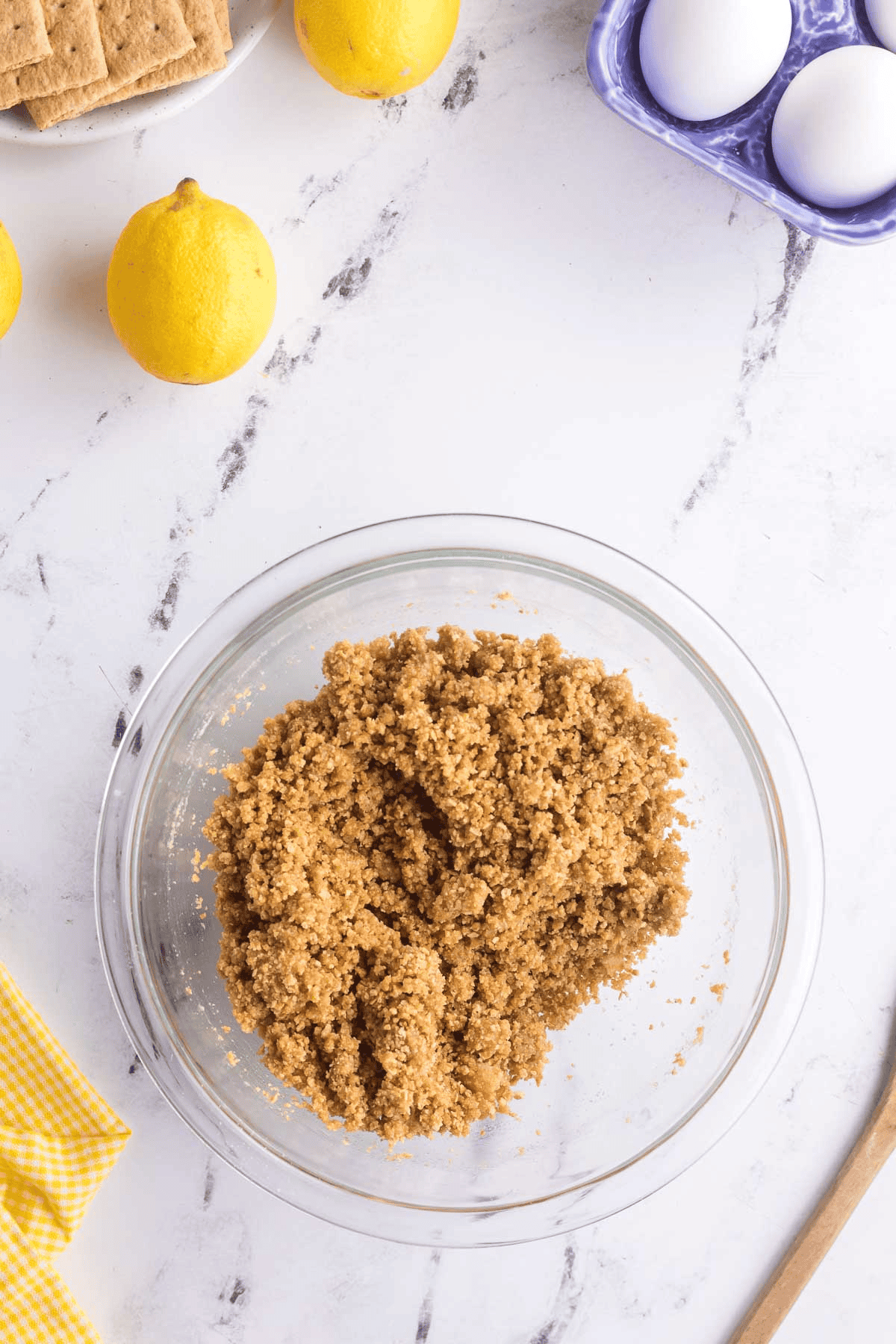 graham cracker crumbs, sugar and melted butter mixed together into a crumbly mixture in medium bowl