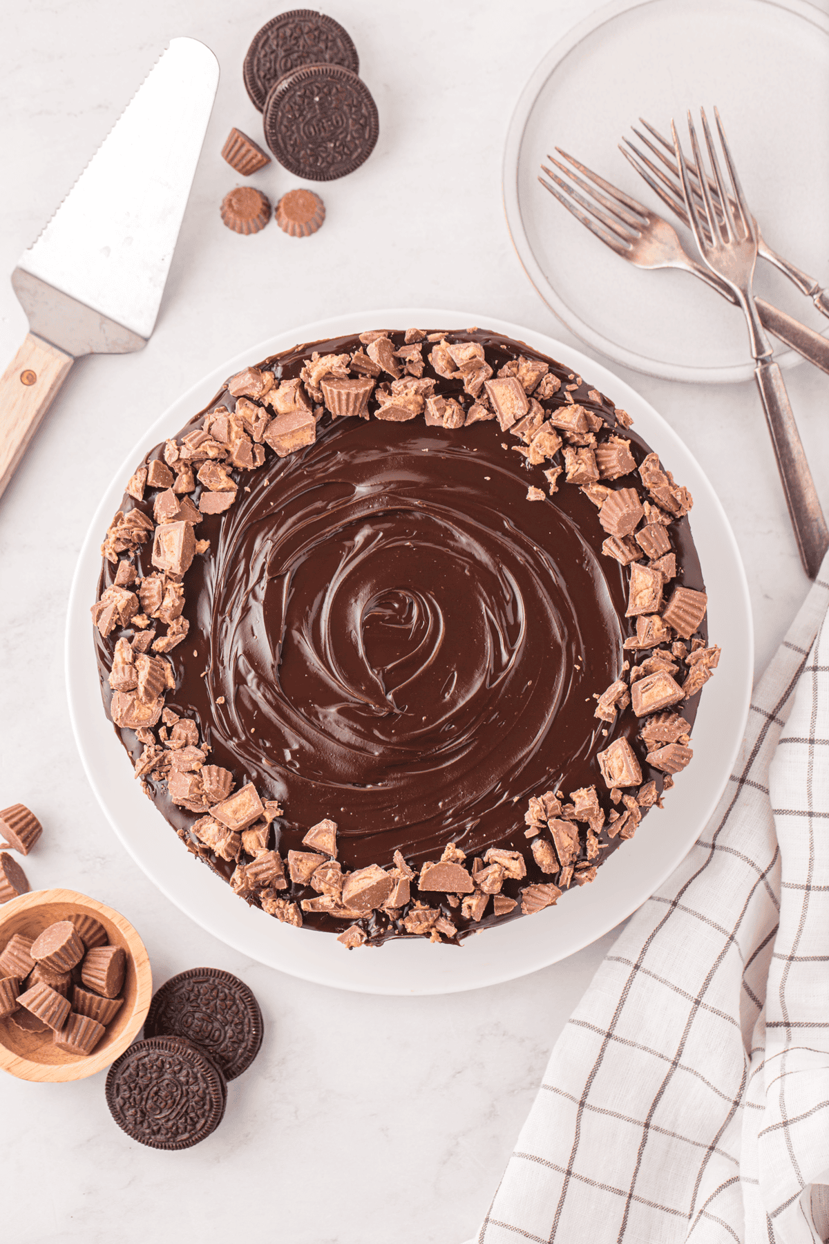 whole no bake peanut butter cheesecake topped with hot fudge and peanut butter cups