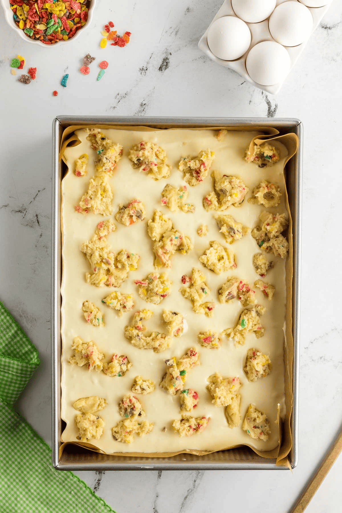 sugar cookie dough crumbled on top of cheesecake layer