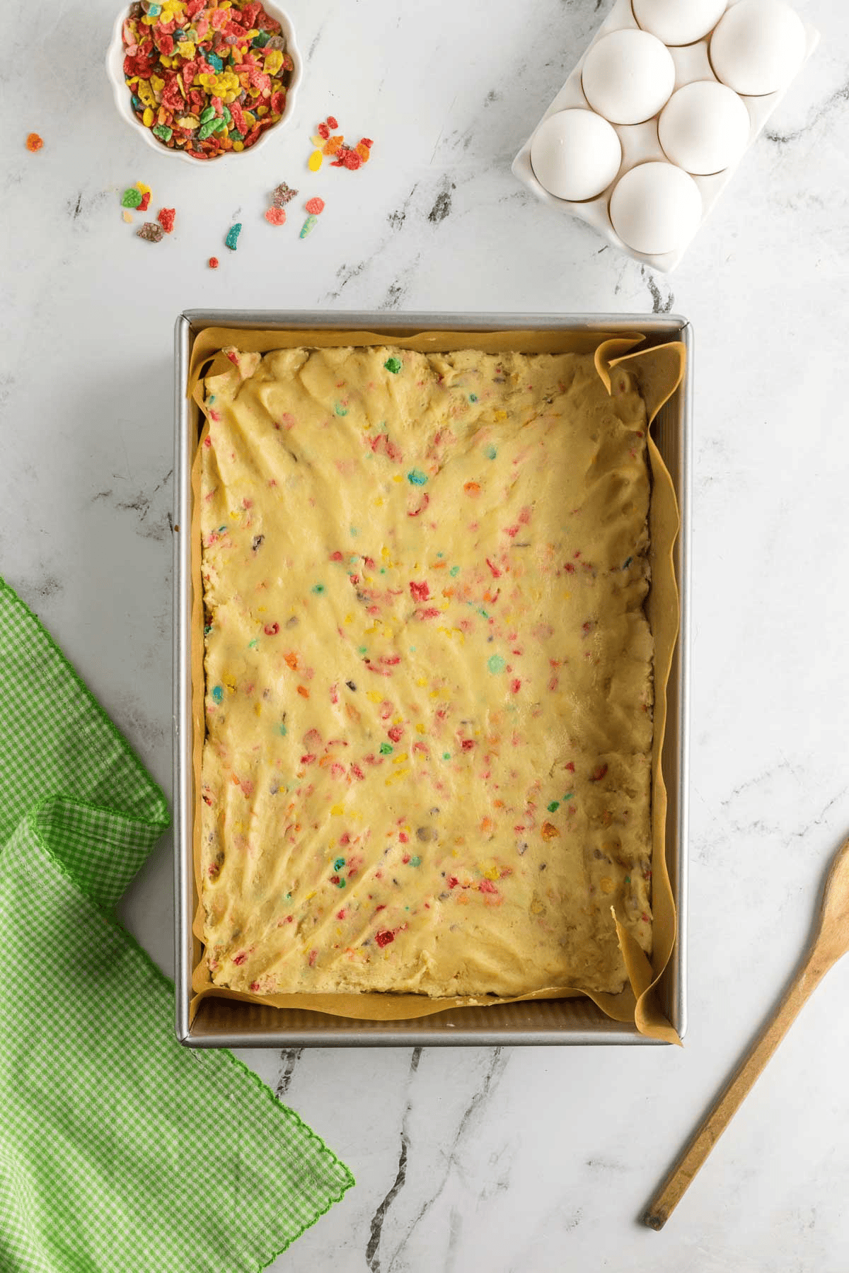 fruity pebble sugar cookie dough pressed into pan