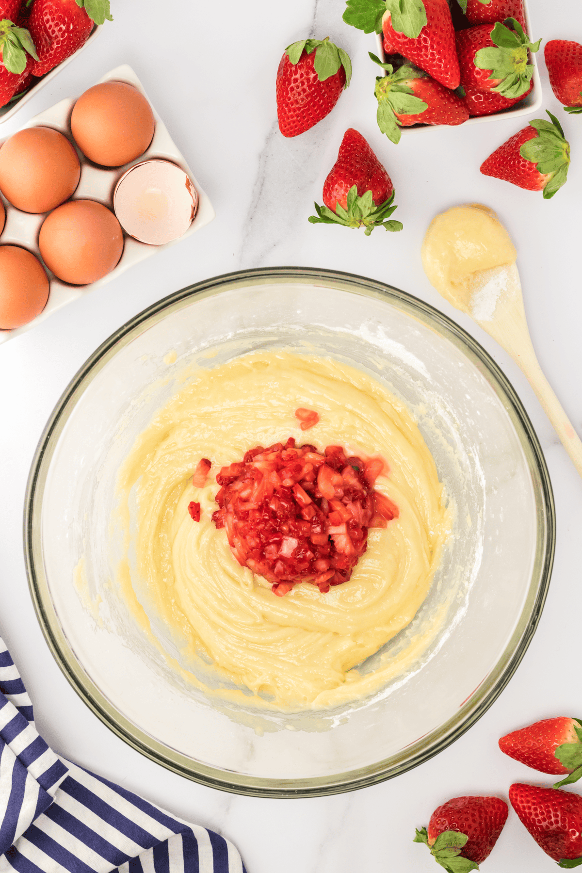 chopped fresh strawberries in donut batter in bowl