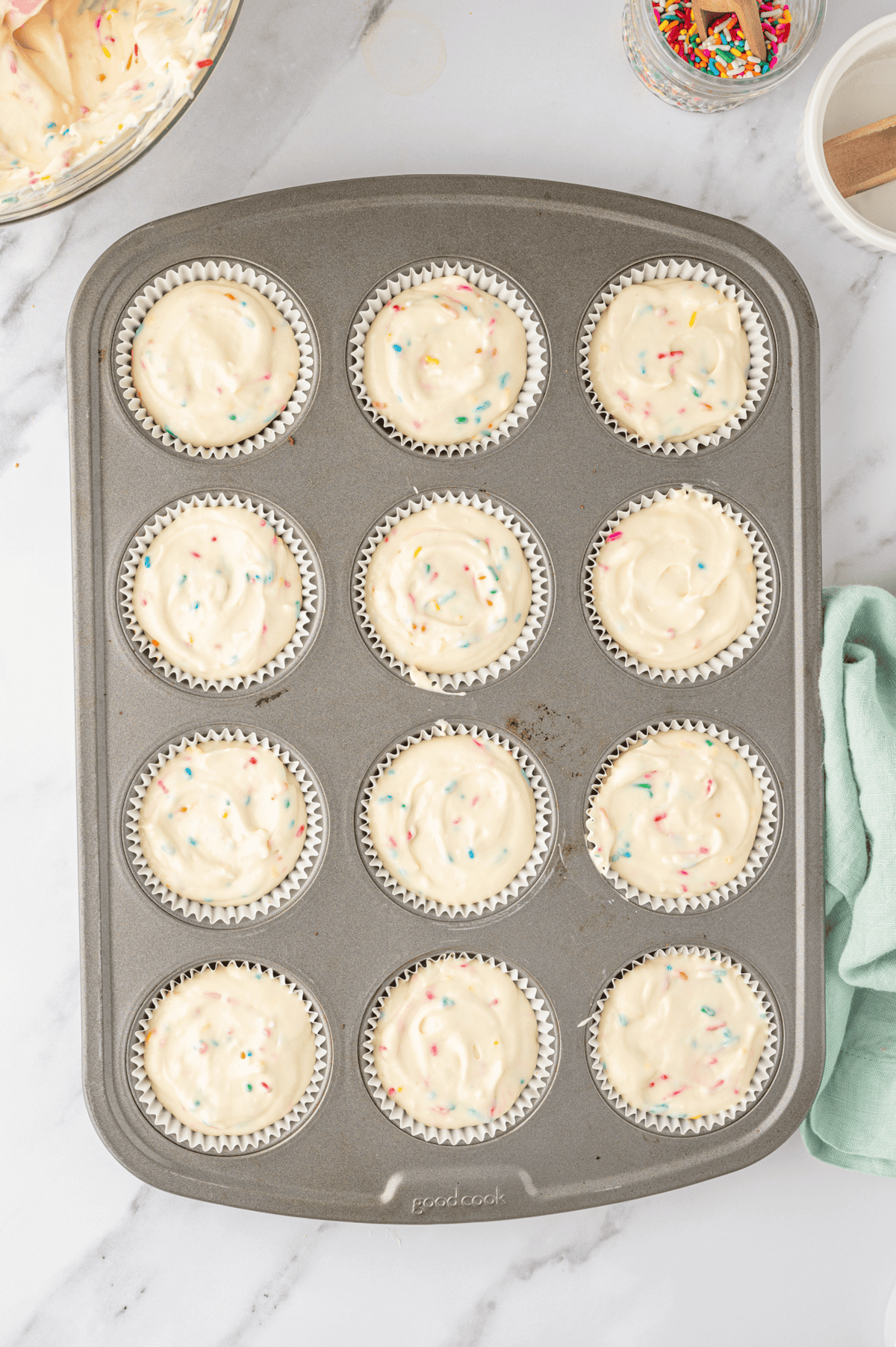 unbaked mini funfetti cheesecakes in muffin pan