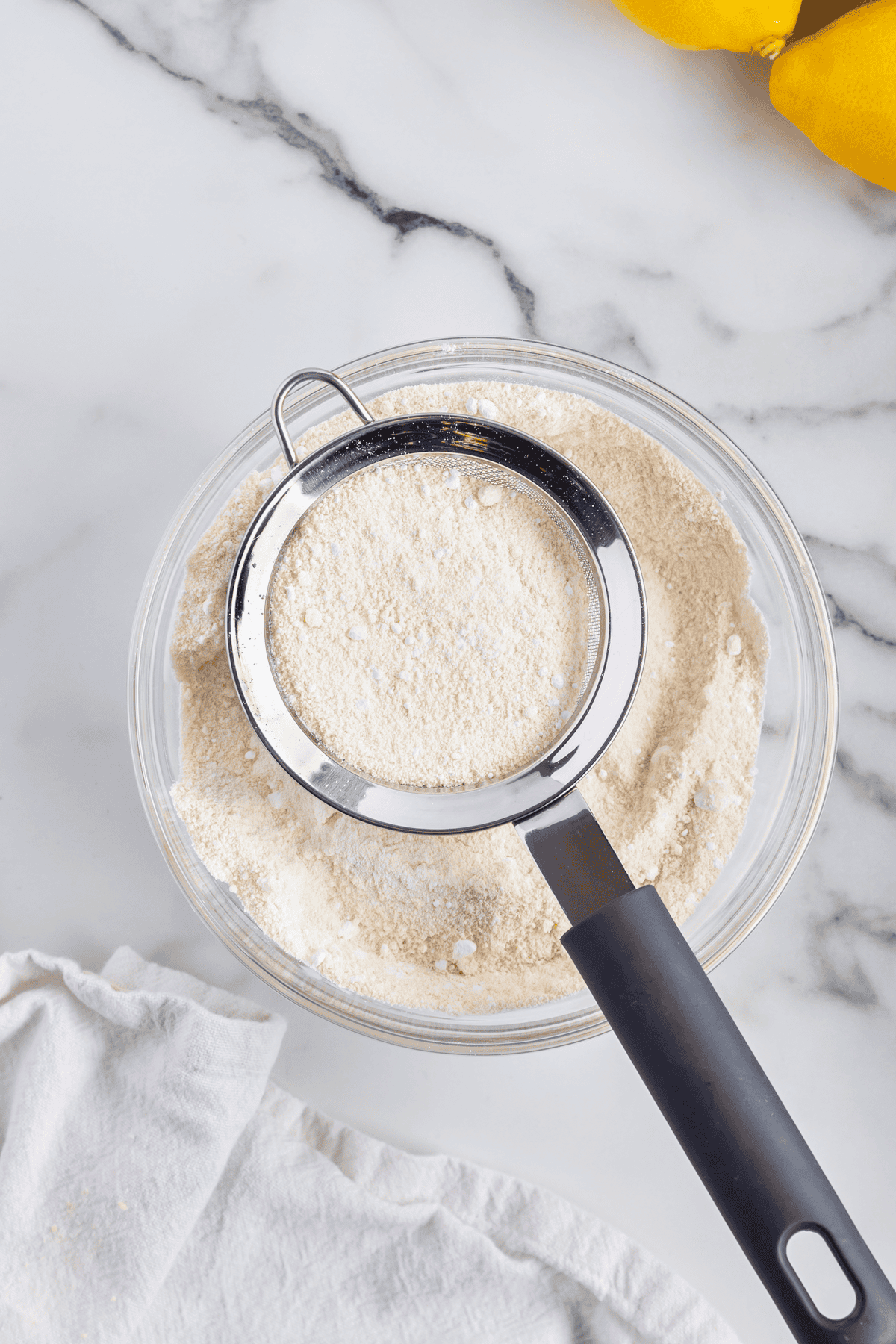 almond flour being sifted