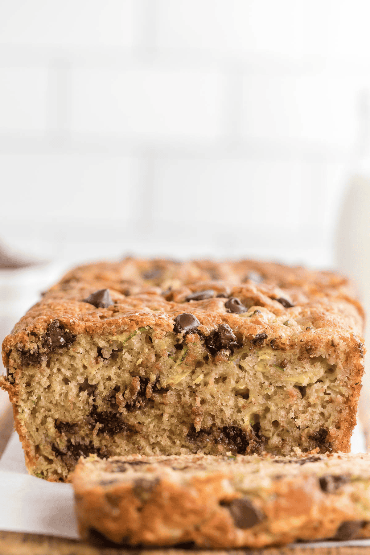 chocolate chip zucchini bread loaf sliced on a cooling rack