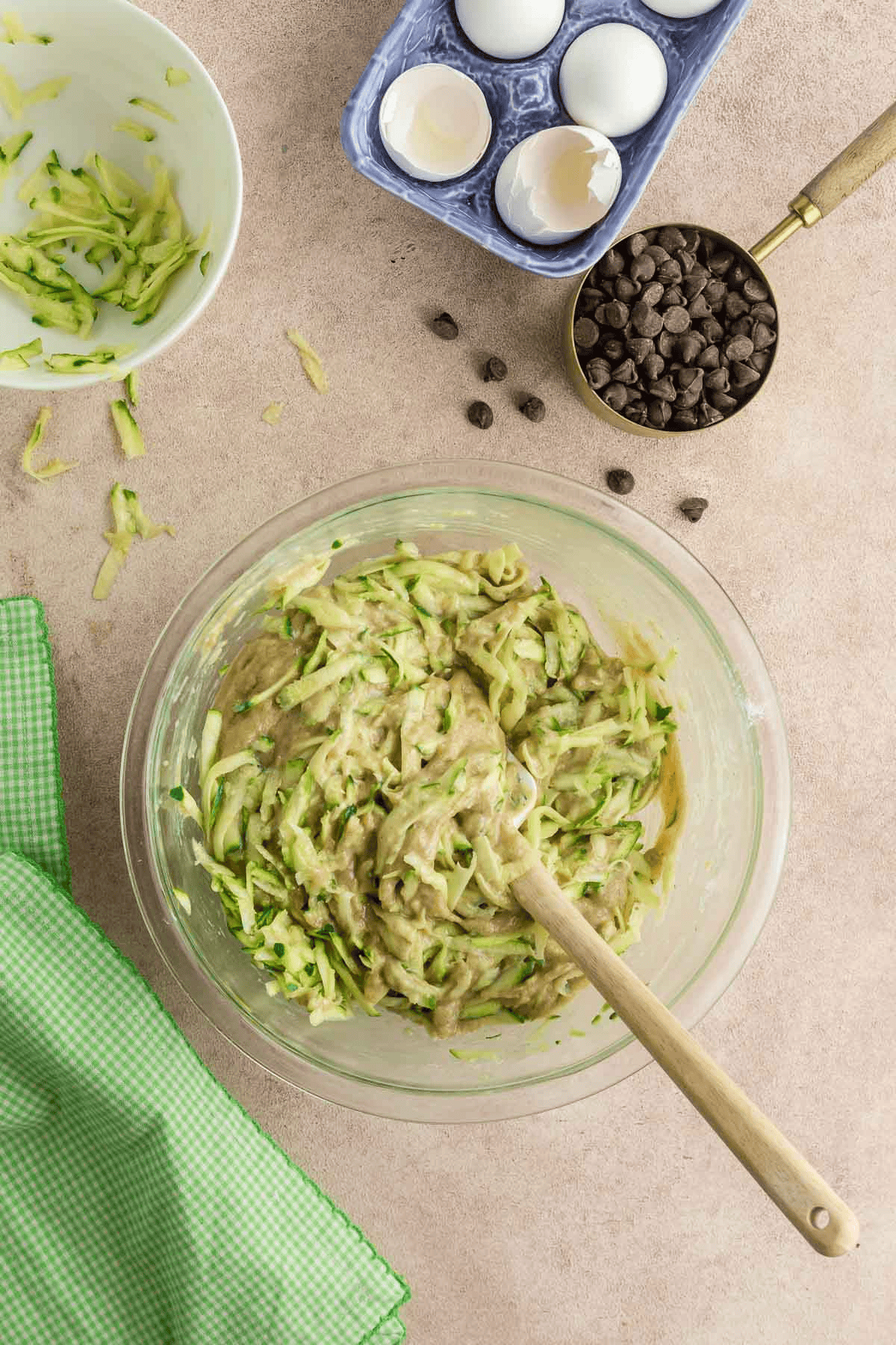 chocolate chip zucchini bread batter with grated zucchini in bowl with spatula