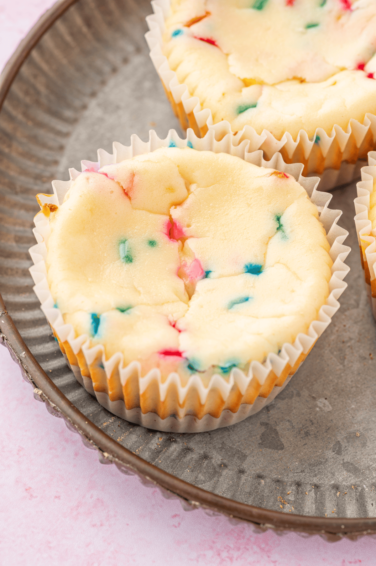 baked mini funfetti cheesecake on silver tray