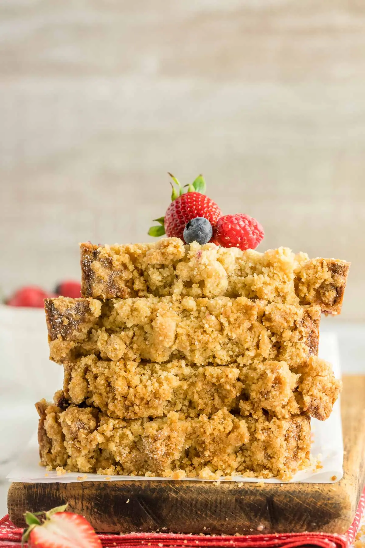 four slices of triple berry bread stacked topped with extra berries
