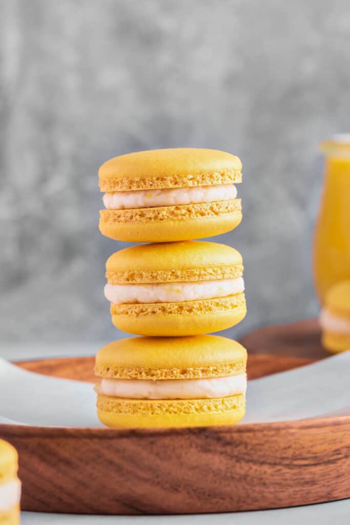 three lemon macarons stacked on top of each other