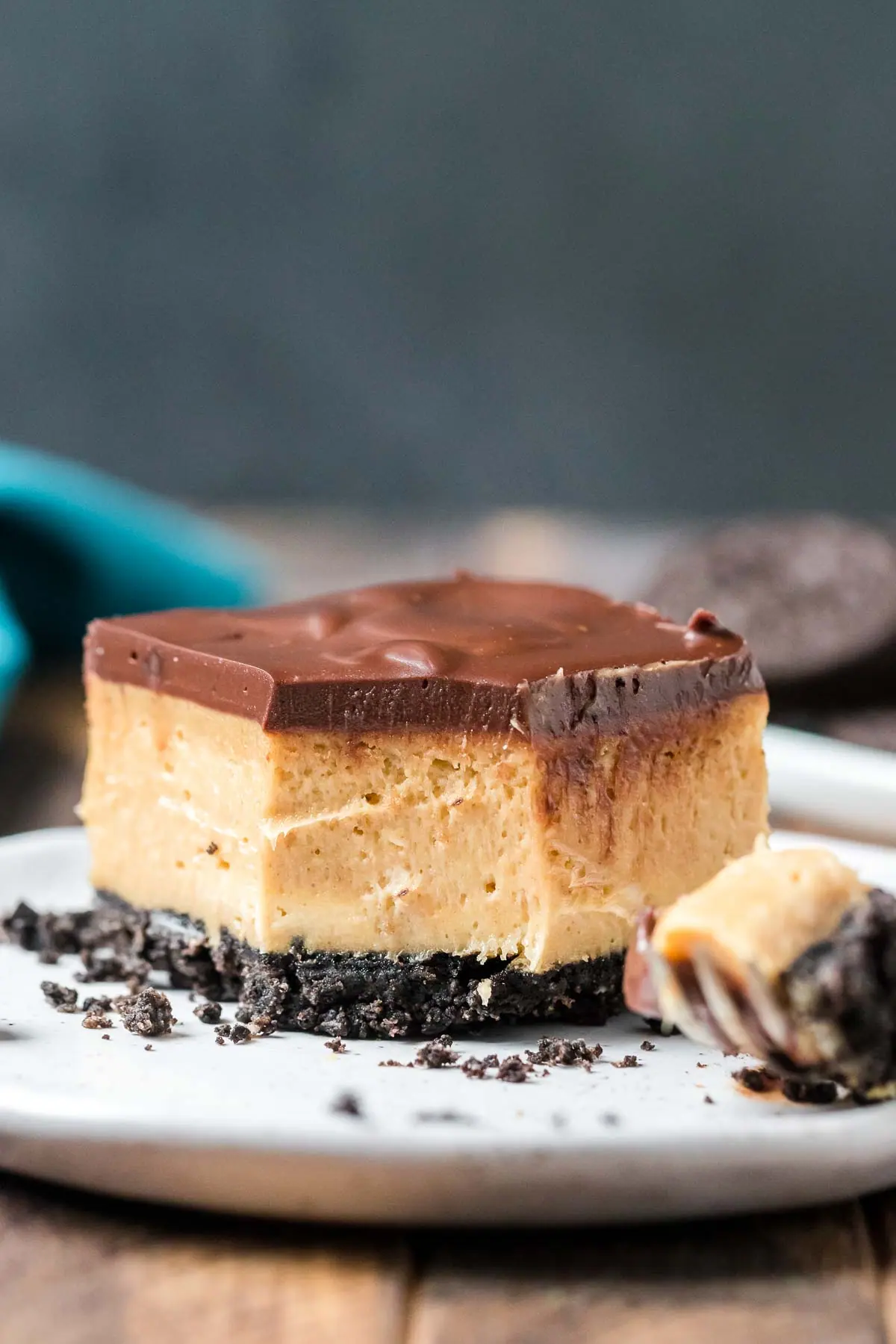 buckeye chesecake bar on a plate with a forkful taken out of it